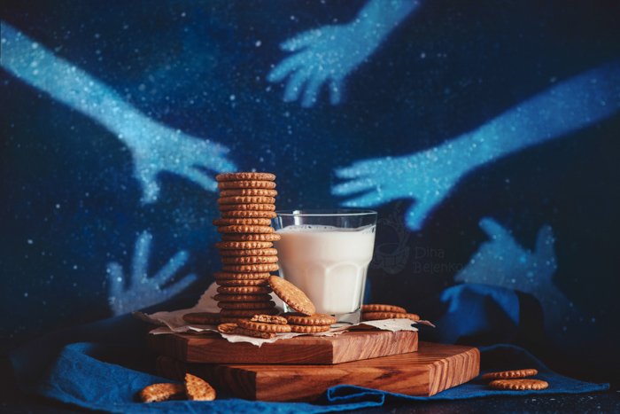 Creative food still life including milk and cookies