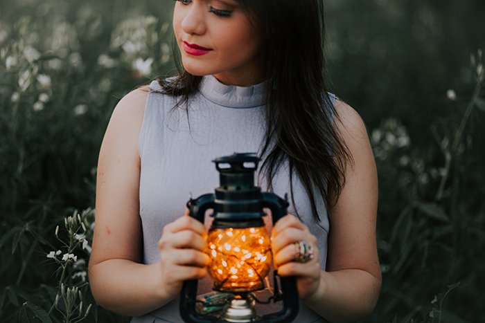 outdoor portrait of a female model holding a lantern - fairy light photography 