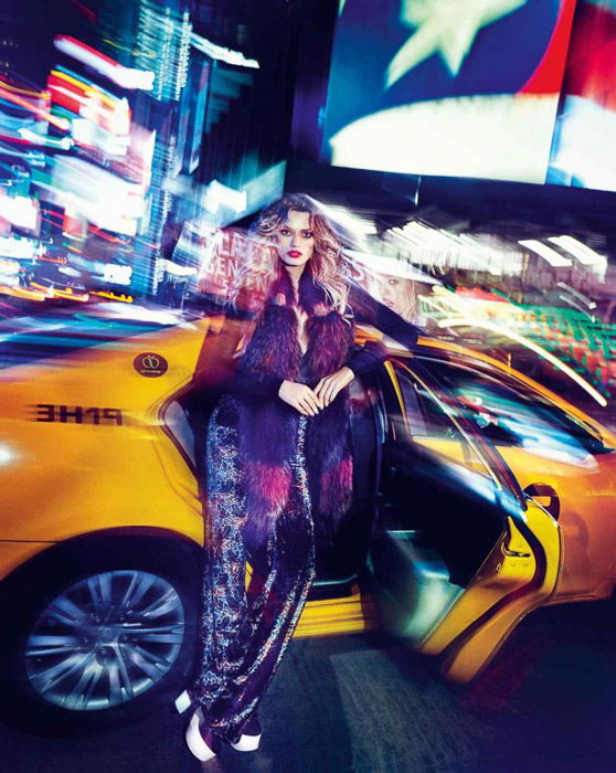 Striking potrrait of a femal fashion model posing by a taxi - outdoor fashion photography at night