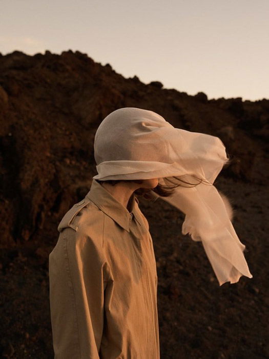 photo by Emma Tempest of a fashion model whose face is covered by a scarf