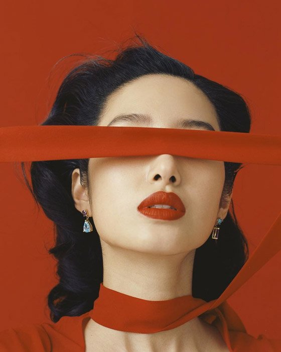 A fashion model with red scarf on red background by Leslie Zhang for example