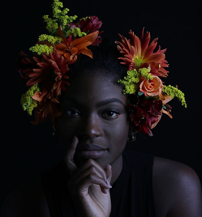 Atmospheric portrait of a female model posing indoors with flowers in her hair - how to photograph the female face 