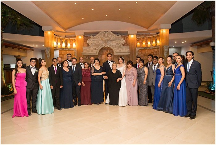 A group photo of a wedding party posing indoors - wedding flash photography