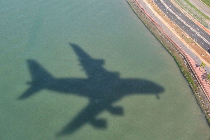 The shadow of an airplane in flight on water