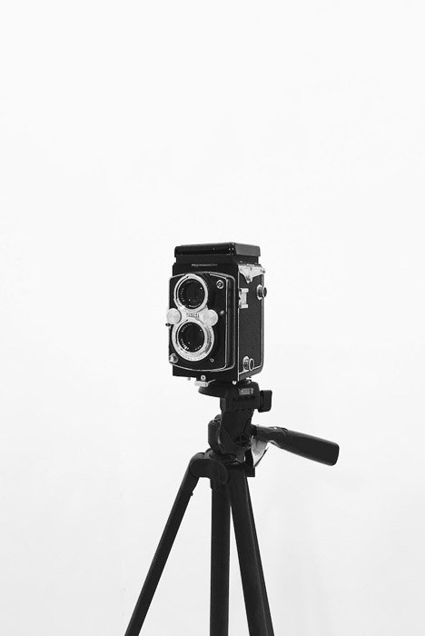 A vintage film camera on a tripod - photography business equipment