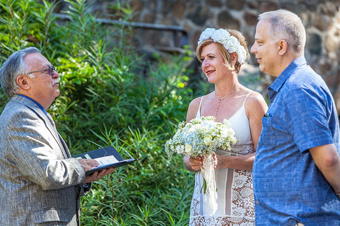 A wedding portrait of a couple being married outdoors