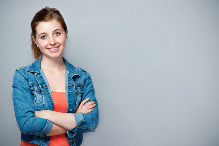 A school portrait of a female students casually against a grey background - tips for quality school portraits