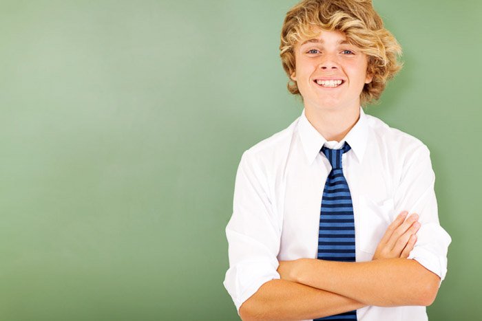 A school portrait of a male student casually against a green background - tips for quality school portraits
