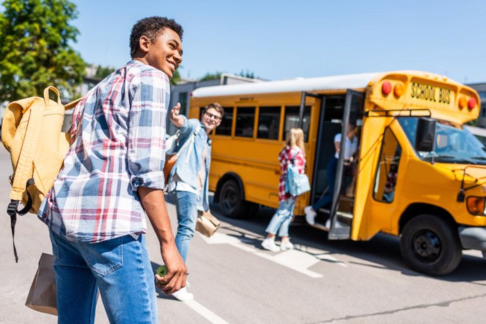 Students boarding a yellow school bus on a clear day - school portraits tips