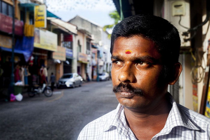 A close up portrait of a man standing on the street 