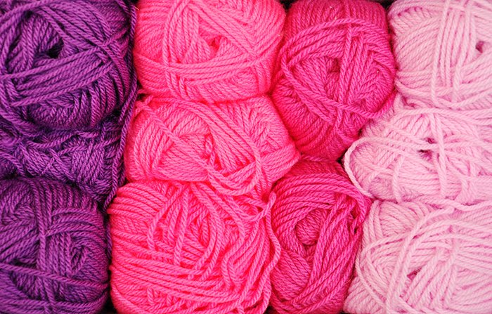 Lines of pink and purple balls of wool - using vibrant colors in photography