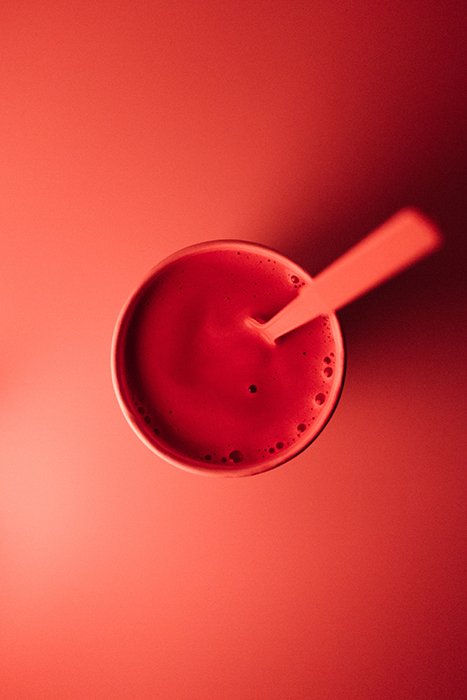 Overhead shot of a red drink on reddish background - using vibrant colors in photography
