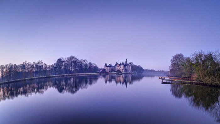 Beautiful panorama of a castle in the background of a peaceful lake