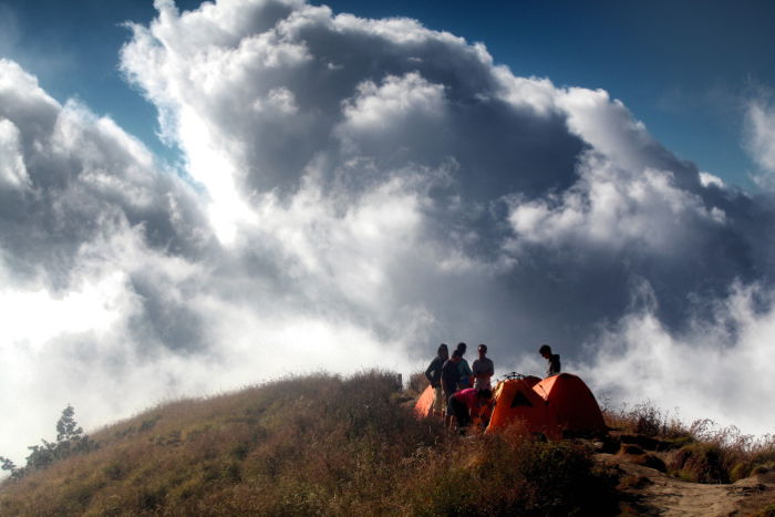 A group of people at a campsite during an adventure photography trip