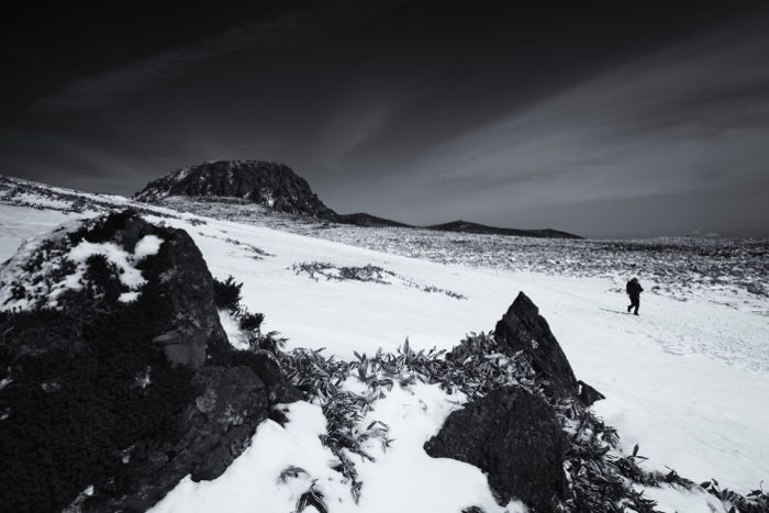 A hiker walking through a stunning snowy landscape