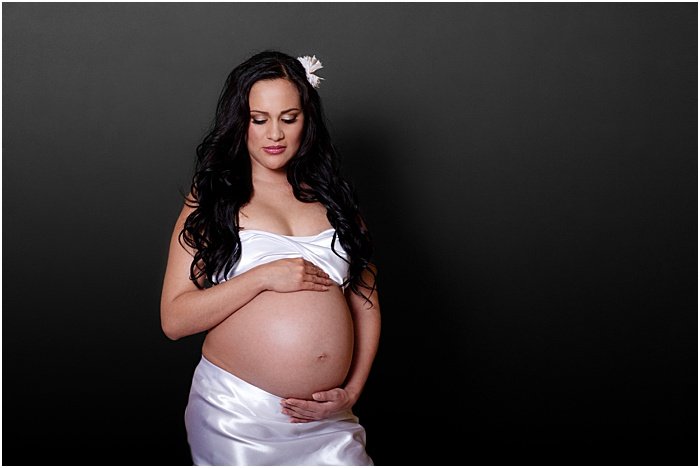 A sweet maternity portrait of a pregnant woman taken in a portable photo studio