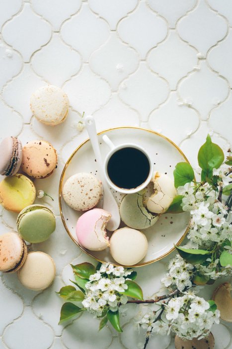 Cute food themed still life featuring macaroons, coffee and flowers - spring photography ideas