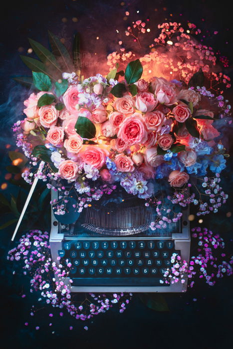 Creative still life of a flower covered typewriter shot with a speedlight