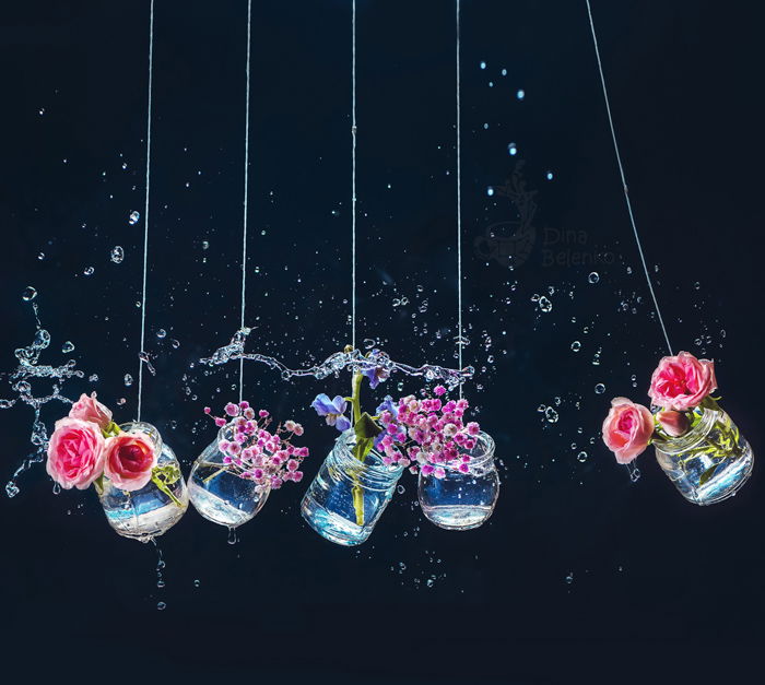 Creative floral themed still life of flowers in glass jars shot with a speedlight