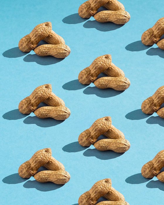 Artistic still life featuring peanuts on a blue background shot with a speedlight