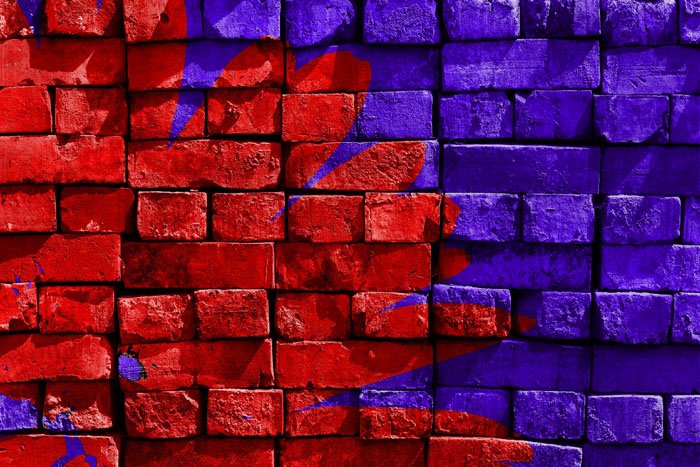 an example of analogous colors on a red and purple painted brick wall
