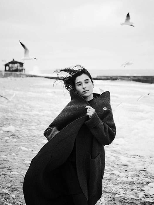 A monotone portrait of a female model walking on a beach - beautiful photography principles
