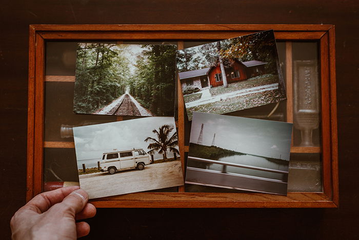 A close up of a person selecting photos to make their own photo book 