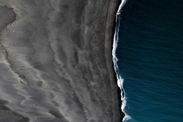 Aerial landscape photo of the sea coming into a beach - using color theory in landscape photos