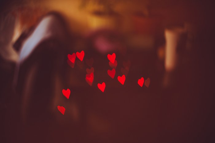 pretty heart shaped bokeh lights on dark background