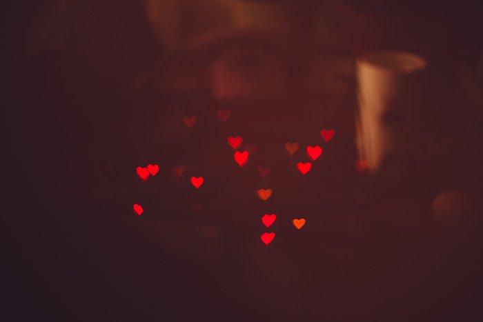 pretty heart shaped bokeh lights on dark background