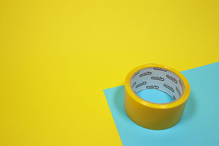 A roll of tape on blue and yellow background for making heart shaped bokeh photography