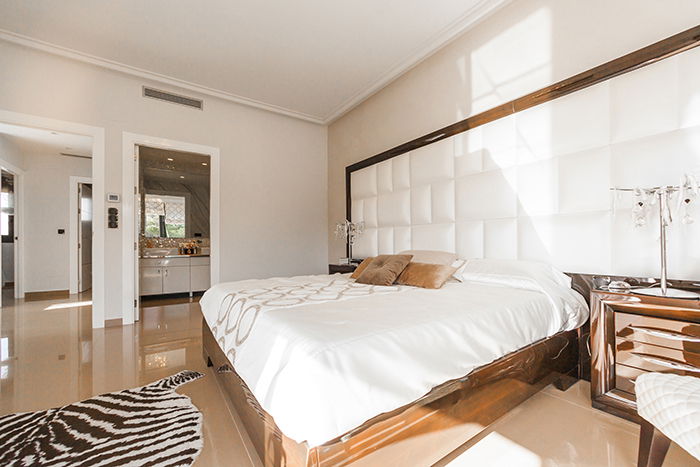 bright and airy photo of the interior of a bedroom shot in natural light