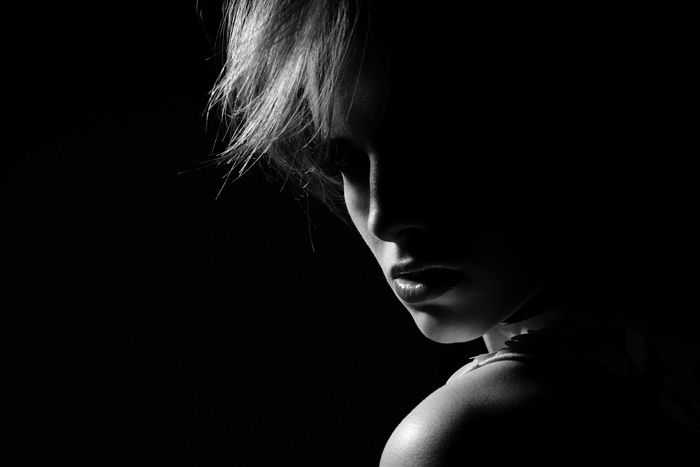 Atmospheric monotone portrait of a female model looking moodily at the camera