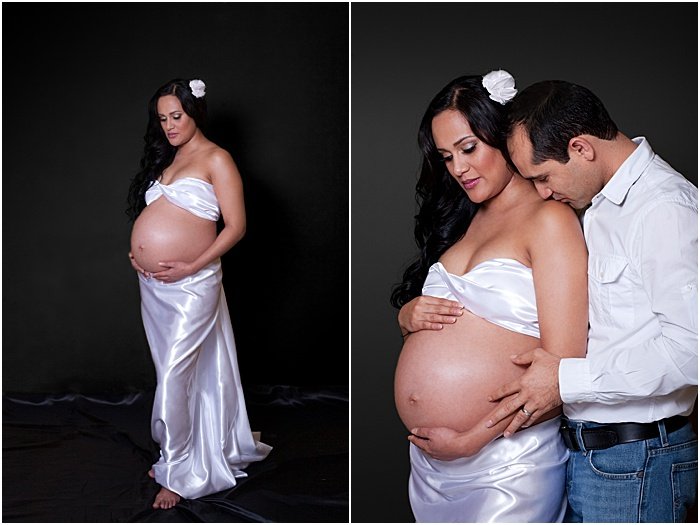 A sweet maternity portrait of a pregnant woman and loving couple taken in a portable photo studio