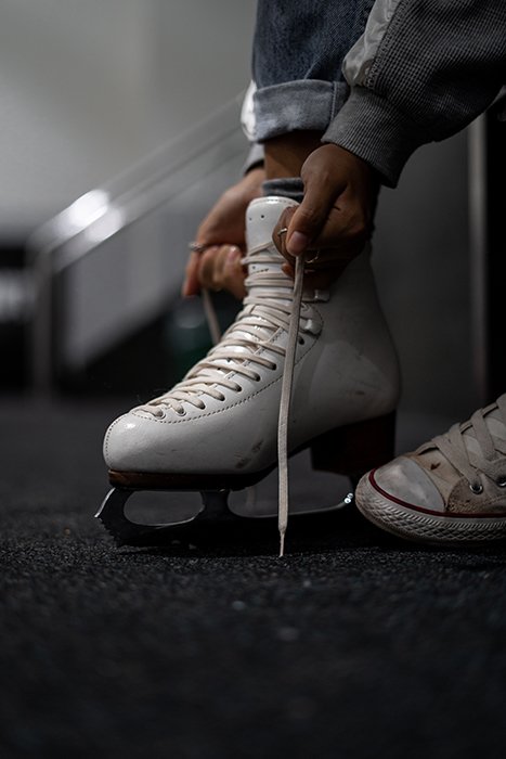 lose up of a skater tying the laces on their ice-skates 