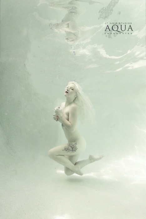 Atmospheric underwater portrait of a female model posing underwater