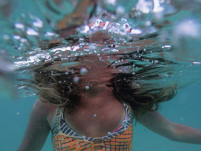 Atmospheric underwater photo of a female swimmer