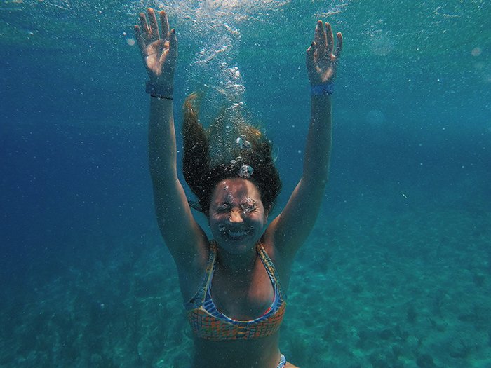 Cool underwater portrait of a female swimmer laughing