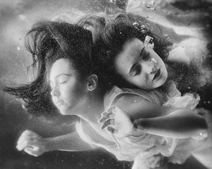 Atmospheric underwater photo of two female models