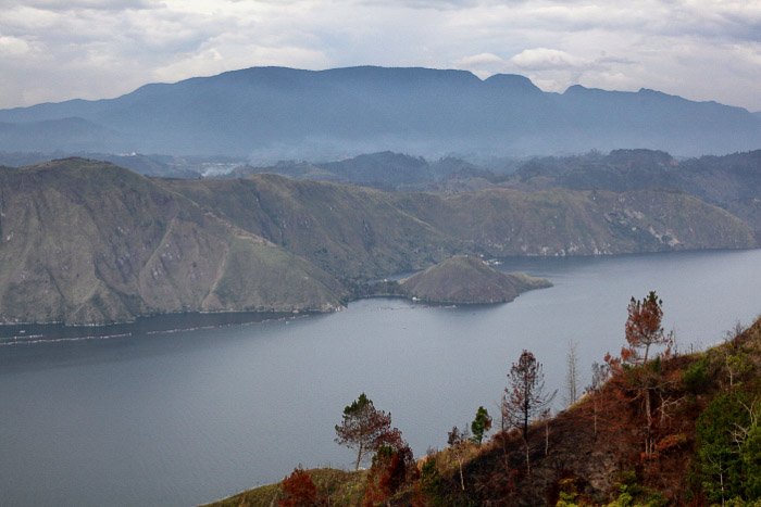 steep mountains surrounding the lake, the caldera of Toba volcano. -volcano and lava photography
