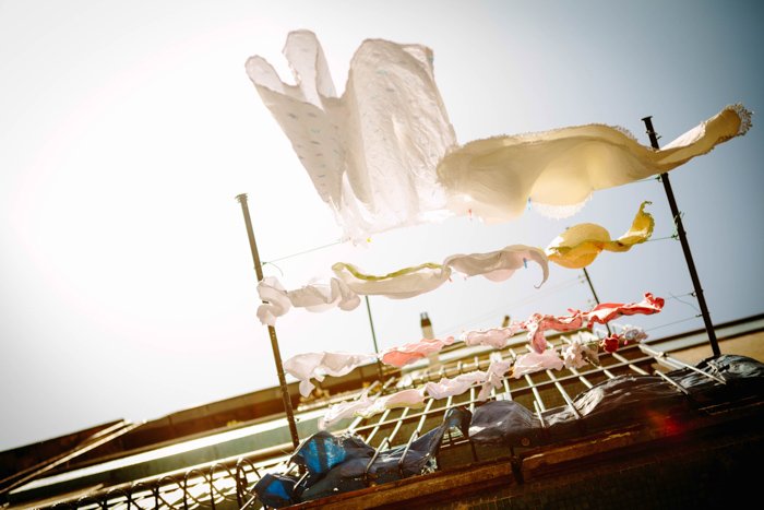 creative photo of laundry hanging outside a balcony shot from a low angle 