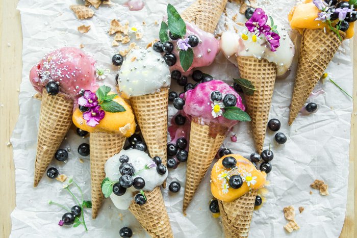 creative summertime themed still life featuring ice cream and berries