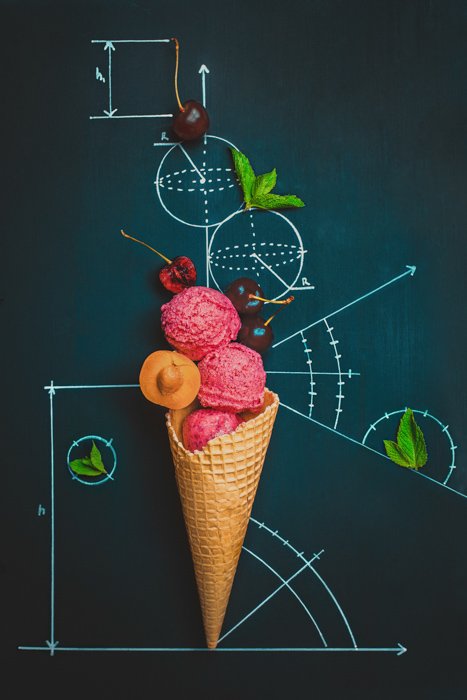 creative still life featuring ice cream and berries on a black board