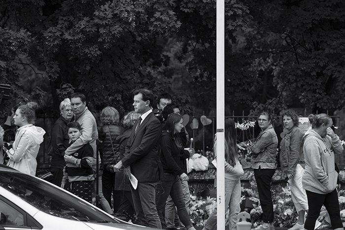 A news reporter at a floral tribute in Christchurch, New Zealand, following a terrorist attack. 
