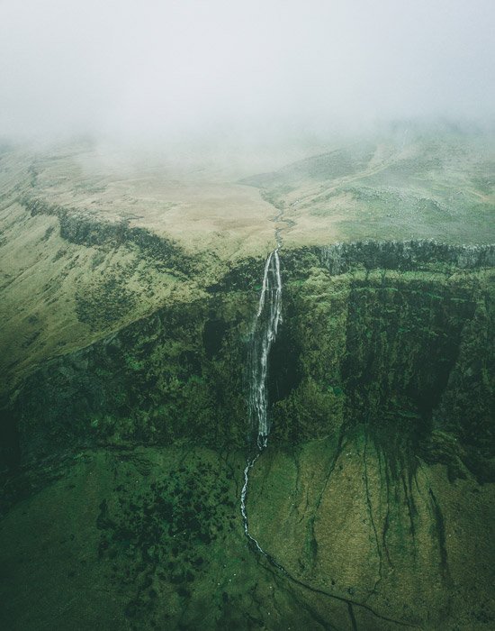 a birds eye view of a beautiful mountainous landscape with a waterfall - stunning landscape photos 