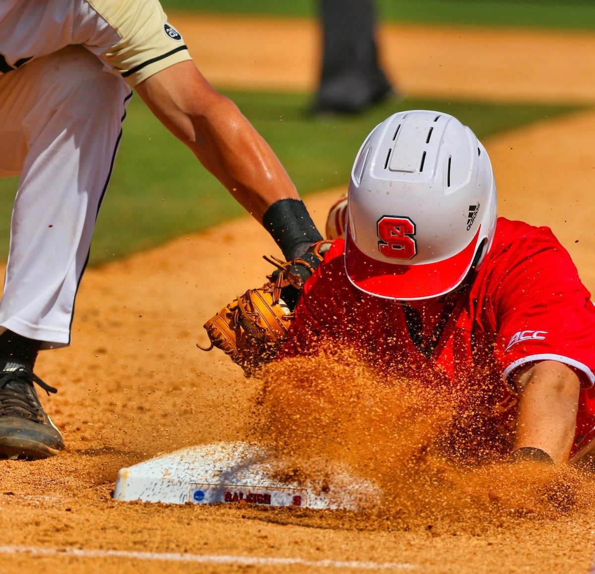 Close-up of a playing being tagged while sliding head first into a base as an example of baseball photography