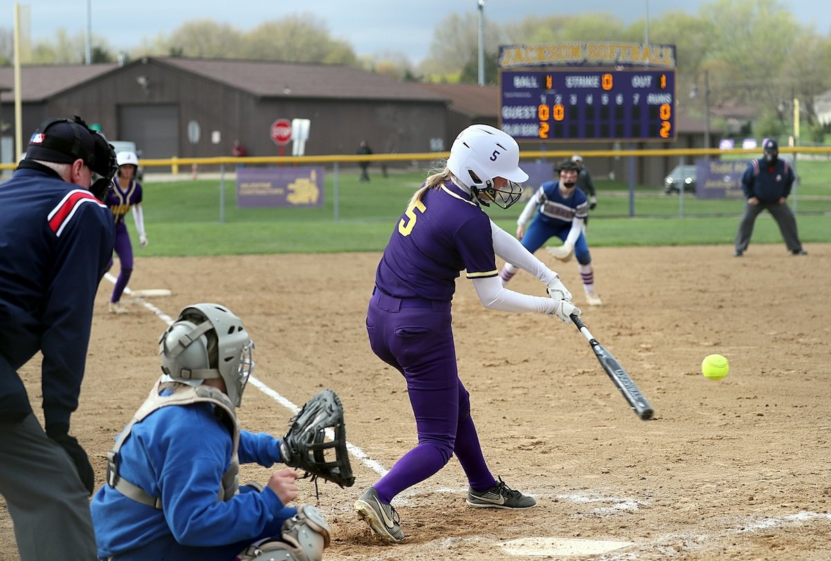 A softball player about to hit a ball at home plate as an example for baseball photography