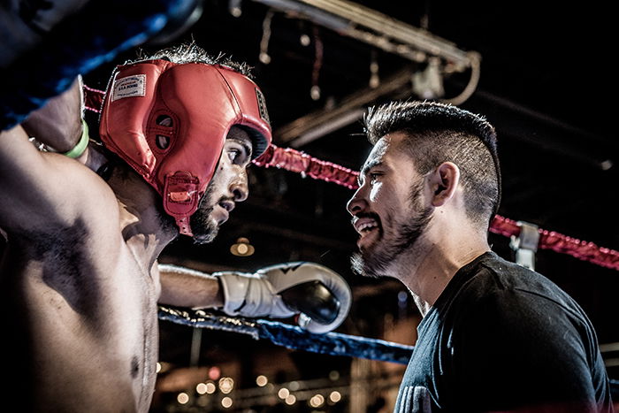 Atmospheric boxing pictures of a fighter talking with a trainer during a boxing match