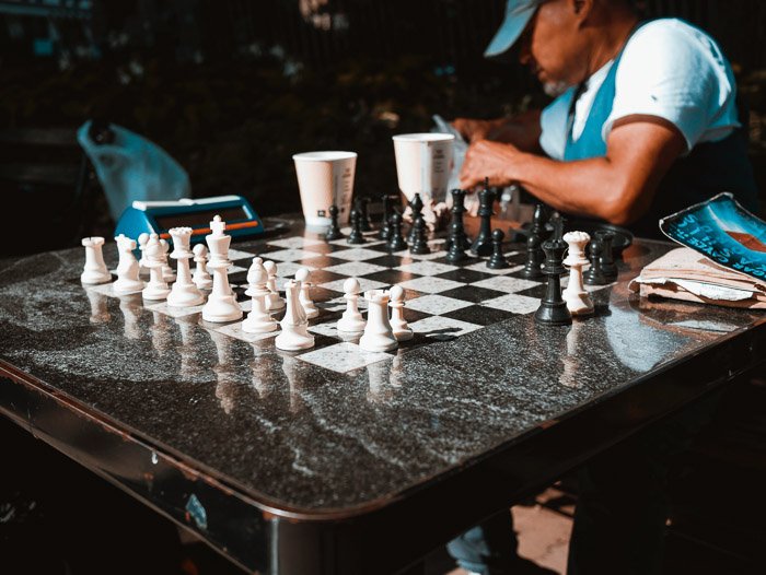 Candid chess photography shot of an outdoor board and chess players
