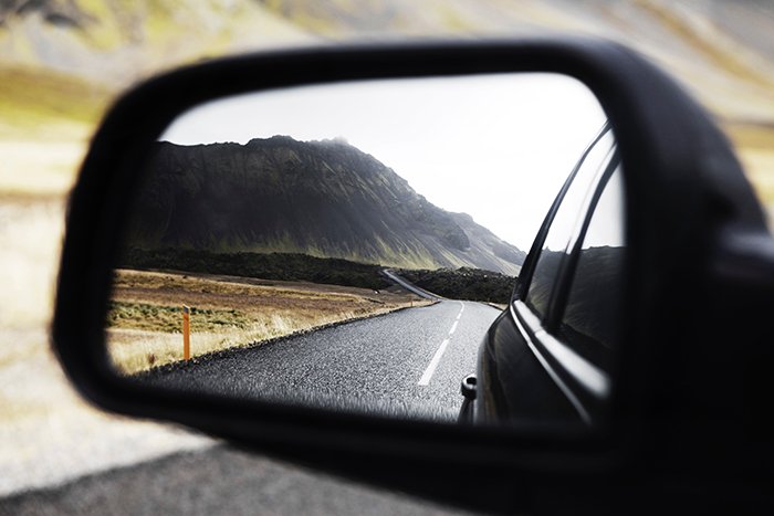 A stunning view of a mountainous landscape shot through a car mirror - Iceland photography tips